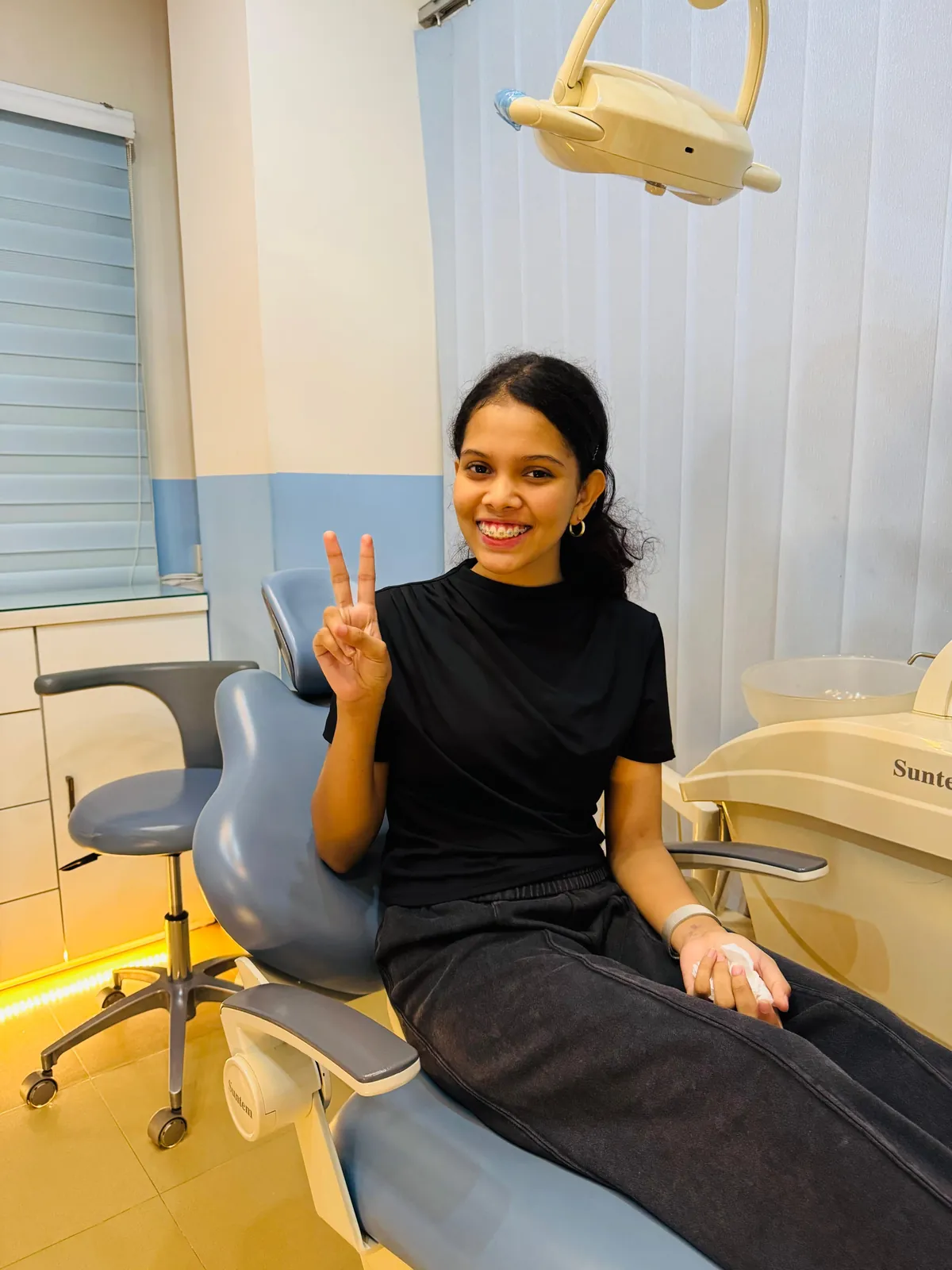 A close-up of braces being adjusted with precision instruments